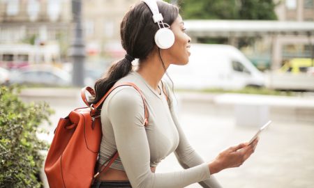 Canva Shallow Focus Photo of Woman Holding Smartphone While Listening to Music