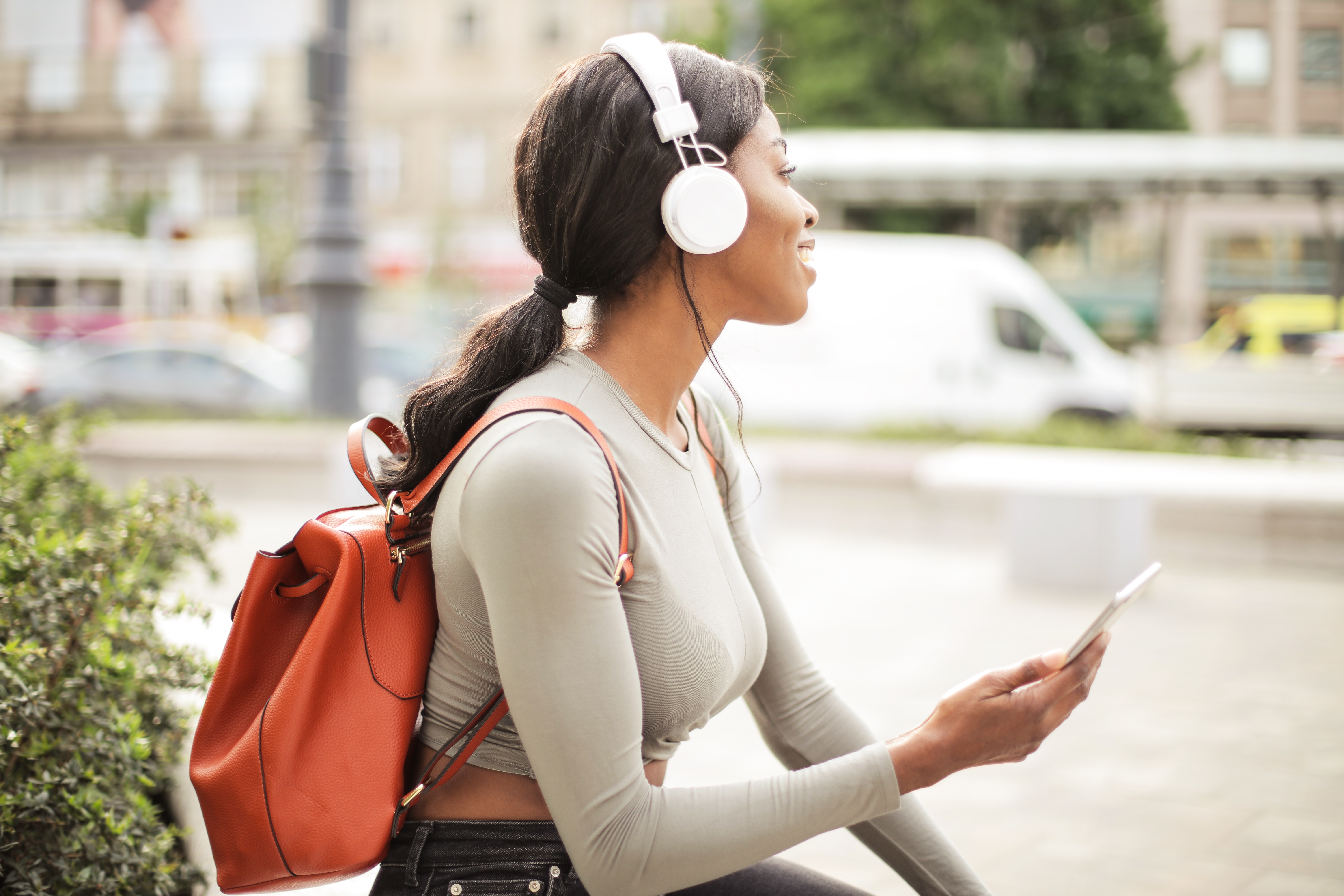 Canva Shallow Focus Photo of Woman Holding Smartphone While Listening to Music
